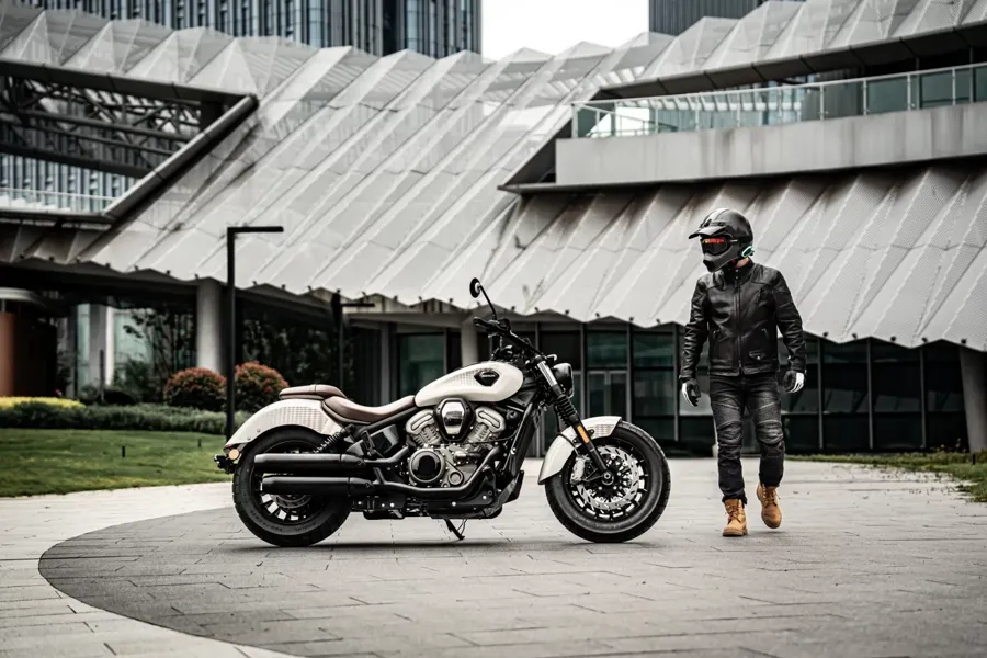 Benda Dark Flag 950 cruiser parked in front of a modern building with its rider standing beside it