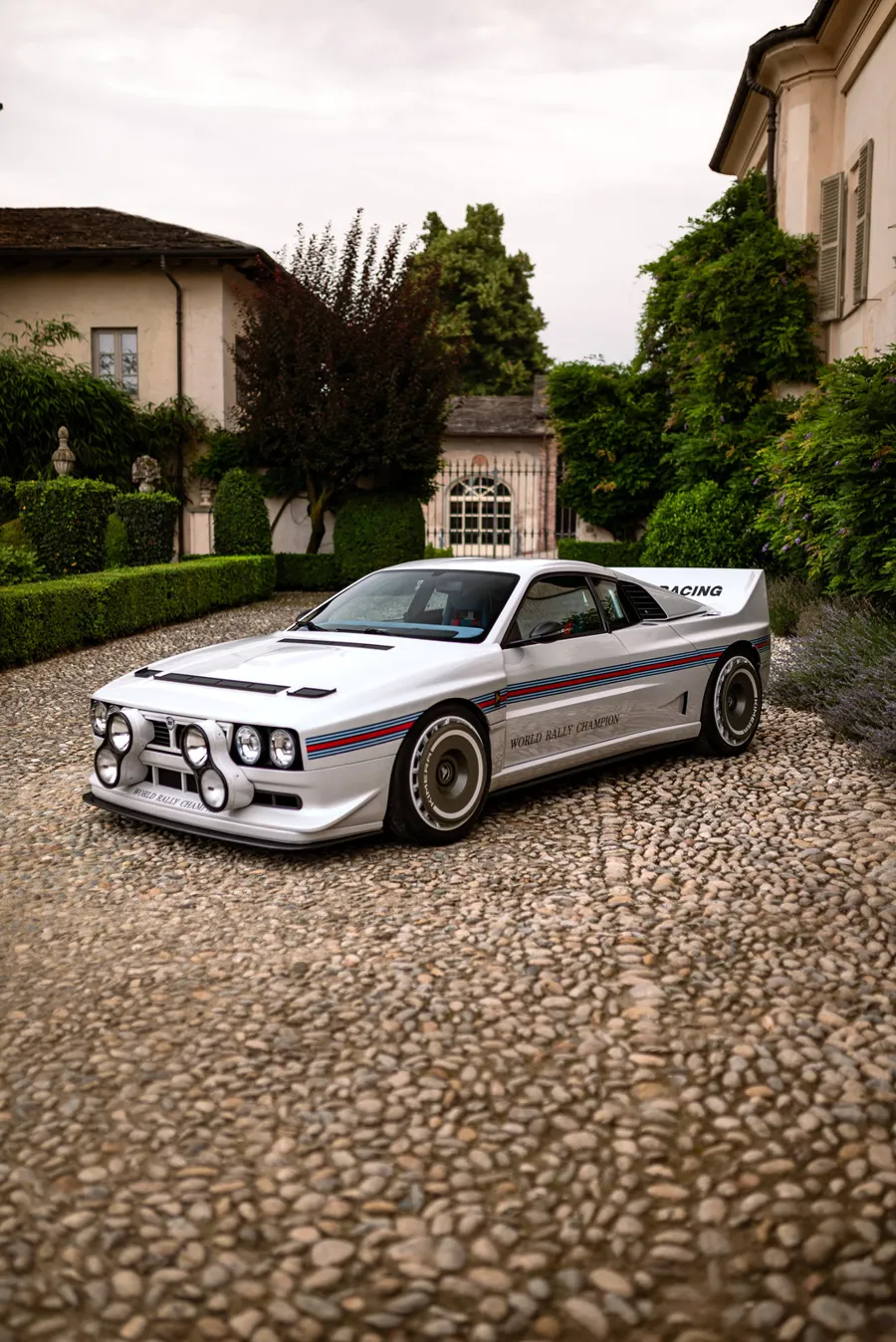 Kimera EVO37 in white Martini livery parked on a gravel courtyard